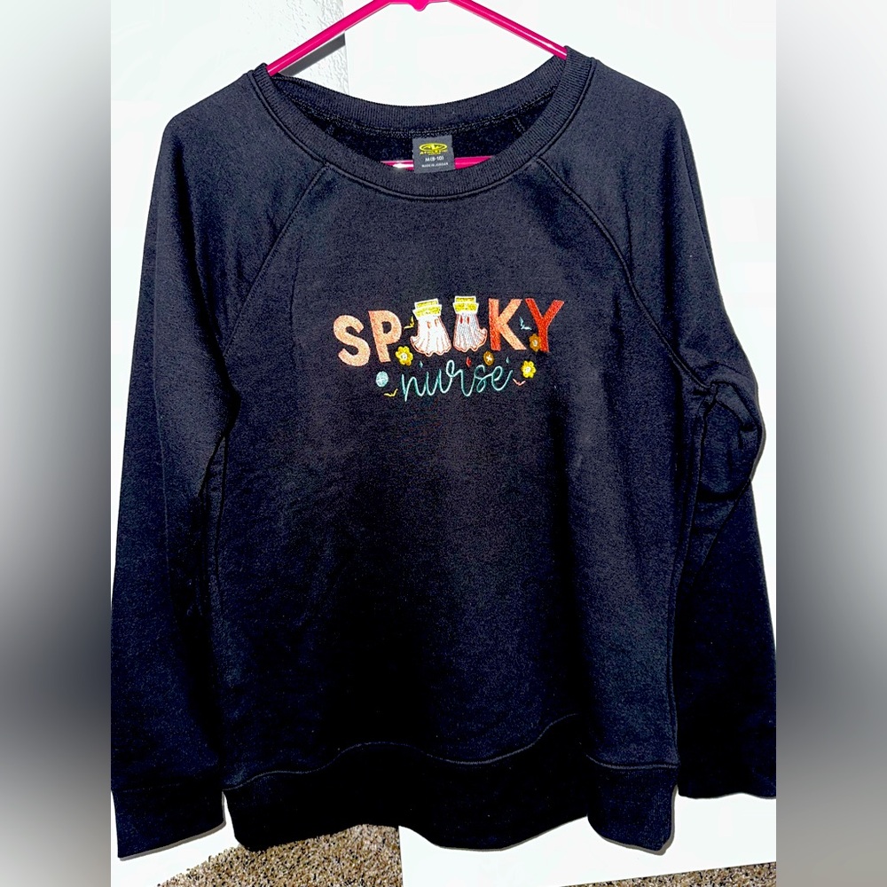 NWOT Pullover Sweatshirt Features Embroidered Spooky Nurse logo